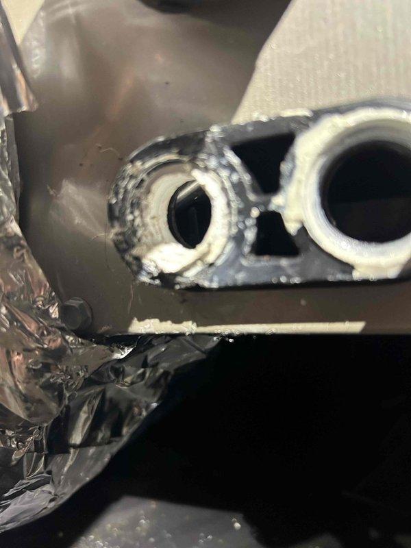 Responded to water leak complaint from HVAC system. Inspected attic unit where condensate drain system showed signs of previous repair attempts with visible white sealant residue around drain connections. Identified faulty condensate pump and compromised drain line as source of recurring leakage. Repaired connections and verified proper drainage operation.