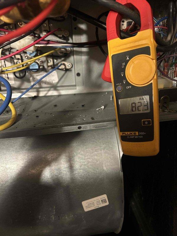 Responded to no-heat call for 6-year-old electric furnace system. Investigated burning smell and system non-response. Diagnostic testing with Fluke 302+ clamp meter revealed electrical fault in control panel (reading 023). Inspected ductwork and electrical connections, then repaired faulty wiring in junction box to restore system operation.