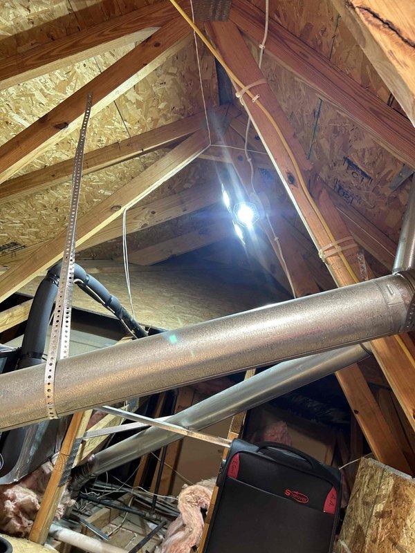 Conducted assessment for tank to tankless water heater replacement. Current installation includes Lochinvar tank water heater installed in utility closet with copper supply lines showing age-related patina and possible moisture issues at base. Evaluated attic space for potential tankless installation, noting adequate structural support, existing ductwork, and electrical access. Customer will supply new tankless unit; quote provided for professional installation services.