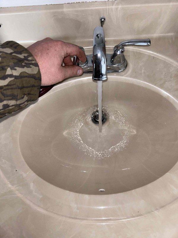 Conducted plumbing inspection of residential mechanical room, focusing on water heater system and associated copper piping. Changed batteries in the Resideo leak detector sensor as requested. Utilized extra-long snake to clear clogged drain. Tested bathroom sink water flow and drainage, confirming proper function after service.