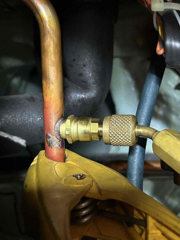 Responded to non-urgent service call for a geothermal system with red indicator light for water flow issue. Performed diagnostic testing of system temperature differential (24°F) and inspected copper piping connections. Serviced the quick-connect brass fitting on the main water line and restored proper system operation, eliminating the flow warning light.