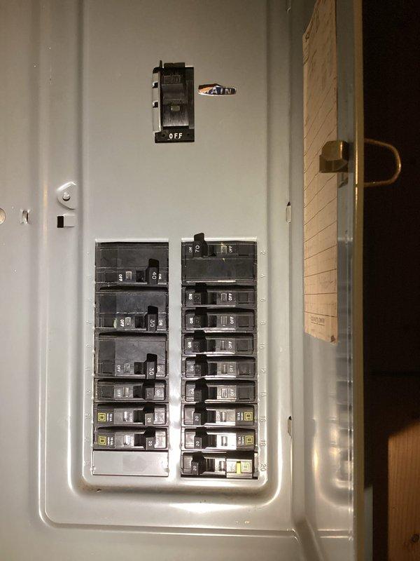 Conducted site assessment for installation of a natural gas Generac standby generator. Inspected main electrical panel (AIR brand) with approximately 20 circuit breakers to determine load requirements and integration capabilities. Evaluated basement workspace area for potential generator control panel location and routing considerations.