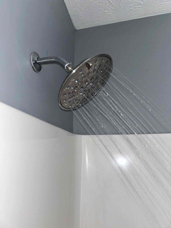 Performed comprehensive 60-point inspection and completed tankless water heater flush service. Verified proper water flow and pressure through both fixed rainfall showerhead and handheld shower component. All fixtures functioning normally with no visible leaks, damage, or mineral buildup detected.