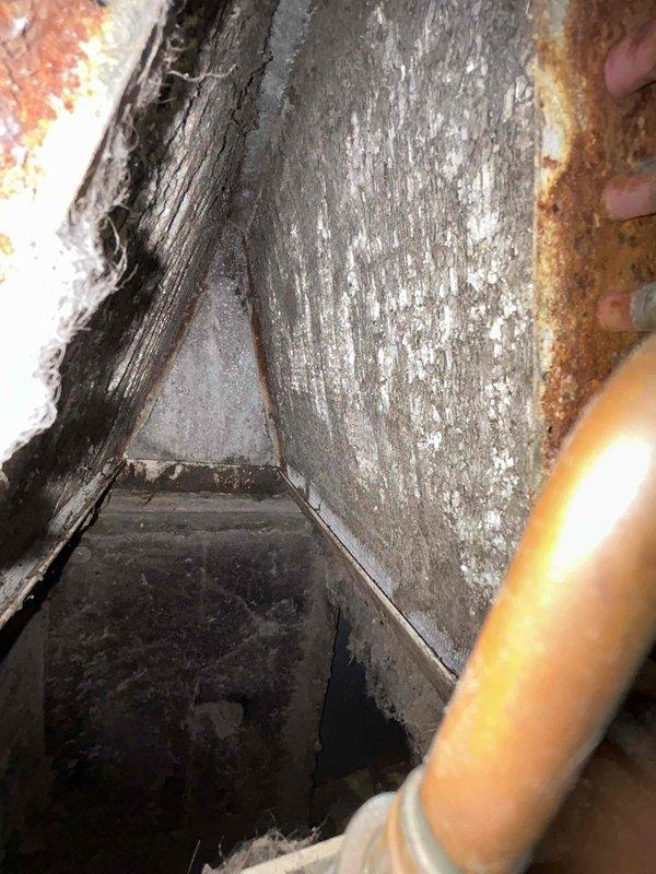 # HVAC Maintenance - Club Duo Service Report

Performed comprehensive preventive maintenance tune-ups on two HVAC systems: heat pump and air handler units, both approximately 20 years old, located in attic and basement installations. Conducted thorough inspections of both units, documenting equipment condition and operational status.

**Attic Unit Inspection:**
Inspected heat pump components and associated ductwork. Documented significant corrosion and deterioration on metal ductwork surfaces, including extensive white mineral deposits and powdery buildup indicating prolonged condensation exposure. Noted advanced rust formation on surrounding metal components and copper refrigerant lines showing oxidation. Assessed structural integrity of ductwork connections and mounting hardware in confined attic space.

**Basement Unit Inspection:**
Examined air handler assembly and mechanical components. Documented severe corrosion on circular mounting flange and connection points, with heavy orang
