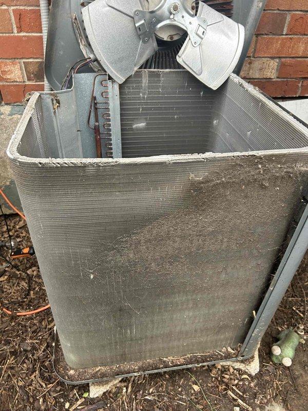 # HVAC Maintenance - Club Single Service Report

Completed comprehensive care plan tune-up service on residential gas furnace and air conditioning system located in laundry room of two-story townhome. Performed standard maintenance procedures including system inspection, cleaning, and filter replacement with new 16x20x1 filter.

Conducted thorough examination of outdoor condensing unit positioned against exterior brick wall. Unit displayed normal operational wear with accumulated dirt and debris on heat exchanger coils and fin surfaces. Inspected dual blower fan assembly, motor housing, and electrical conduit connections at top of cabinet. Assessed overall condition of metal cabinet exterior showing typical weathering from outdoor exposure.

Performed detailed inspection of electrical components including contactor relay assembly. Examined all terminal connections, verified secure mounting of Phillips head screws, and inspected condition of control wiring including orange, yellow, pink