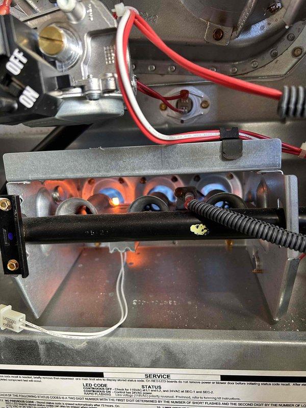 # HVAC Maintenance - Club Single Service Summary

Completed scheduled care plan tune-up service on air conditioning system with gas furnace. Customer provided their own air filter for replacement during maintenance visit.

## Service Performed

Conducted comprehensive preventive maintenance inspection and tune-up on residential HVAC system. Performed visual inspection of gas furnace burner assembly, confirming proper ignition and flame characteristics with blue flame pattern visible across all burner ports. Verified gas valve operation and electrical connections to heating components. Inspected heat exchanger housing and blower assembly for proper condition.

Evaluated REME-HALO air purification system previously installed on ductwork in July 2022. Confirmed unit remains properly mounted and operational with power supply connected. Noted UV light caution labeling present on equipment. Inspected ductwork condition and air purification device integration with HVAC system.

Replaced air f