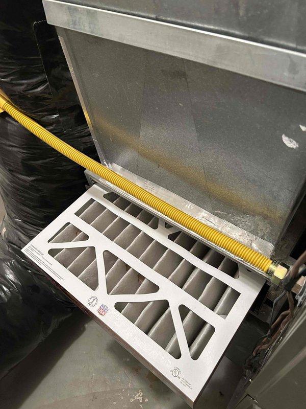 # HVAC Maintenance - Club Single Service Report

Completed spring air conditioning tune-up on residential cooling system as requested. Upon arrival, confirmed system was operating properly with no reported issues. Updated customer contact information in service records.

Performed comprehensive preventive maintenance inspection of air conditioning unit. Accessed air handler compartment and verified air filter condition - found filter to be in acceptable condition with adequate airflow. Documented system configuration including yellow flexible gas line connection and proper ductwork installation. Utilized digital clamp thermometer to measure and verify temperature differentials across the system, confirming proper refrigerant charge and heat exchange performance. All temperature readings fell within manufacturer specifications for optimal cooling efficiency.

Conducted standard seasonal maintenance checklist including visual inspection of all accessible components, verification of prope