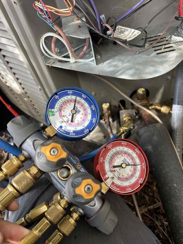 # Service Completion Summary

Responded to service call for 11-year-old Bryant system not cooling to set temperature. Upon arrival, verified system was running but delivering inadequate cooling with air temperature well above thermostat setpoint.

Performed diagnostic evaluation of cooling system components. Inspected condenser unit manufacturer label and specifications to confirm equipment model and operating parameters. Connected manifold gauge set to service ports and measured refrigerant pressures on both high and low sides of the system. Pressure readings indicated system was operating outside normal parameters, consistent with customer's reported symptoms of insufficient cooling capacity.

Evaluated internal components including evaporator coil area, condensate pan, electrical connections, and refrigerant line sets. Checked for proper airflow, examined wire connections for integrity, and inspected copper tubing and brass fittings for signs of refrigerant leaks or restrictions. As