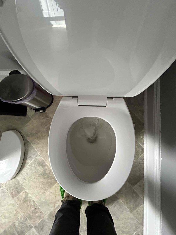 # Plumbing Service Report: Water Leak Investigation

## Service Summary
Responded to bathroom flooding complaint in 106-year-old residence. Conducted thorough inspection of toilet assembly and surrounding plumbing fixtures to identify source of water leak.

## Work Performed

Upon arrival, performed visual inspection of bathroom to assess flooding conditions and locate water source. Examined toilet assembly as primary suspect given proximity to reported flooding area. 

Removed toilet tank lid to inspect internal flush mechanism components including fill valve, flush valve assembly, and flapper mechanism. Verified water level in tank was within normal operating parameters. Inspected tank-to-bowl connection for signs of leakage, corrosion, or deterioration common in older installations.

Examined toilet bowl for cracks, hairline fractures, or porcelain damage that could allow water seepage onto bathroom floor. Checked wax ring seal integrity at toilet base connection to drain flange. In