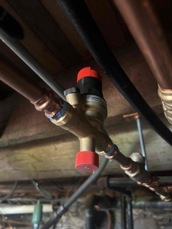 # Service Call Back - No Cooling Issue

Responded to callback for intermittent cooling failure on HVAC system. Upon arrival, inspected control board and thermostat displaying error code 18, indicating a potential refrigerant pressure or sensor issue. Performed diagnostic testing on pressure relief valve and associated copper refrigerant lines in mechanical space. Verified proper operation of control module functions including mode selection and reset capabilities. Documented system components via photographs showing control interface readings and pressure valve configuration. System pressure readings and valve positions were checked and found within normal operating parameters at time of inspection. Advised monitoring for recurring symptoms and provided callback number for immediate dispatch if issue returns. Further investigation may be required if intermittent fault continues to determine root cause of cycling failure pattern.