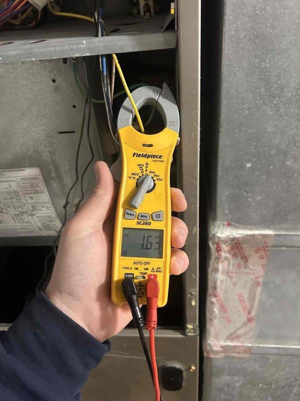 # HVAC Maintenance - Club Single Service Completed

Performed comprehensive preventive maintenance tune-up on heat pump and air handler system located in basement. Conducted electrical diagnostics using clamp meter, recording amperage draw of 16.3 amps on system components to verify proper operation within manufacturer specifications. Inspected electrical connections, capacitor, and control wiring for signs of wear or deterioration.

Thoroughly examined evaporator coil assembly and identified significant contamination with dark staining and moisture-related buildup on lower portions of finned surfaces, indicating accumulated dirt, debris, and possible microbial growth. This condition can restrict airflow, reduce system efficiency, and impact indoor air quality. Documented coil condition with photographic evidence for service records.

Completed standard maintenance checklist including inspection of all accessible system components, electrical connections, and operational parameters. Cu