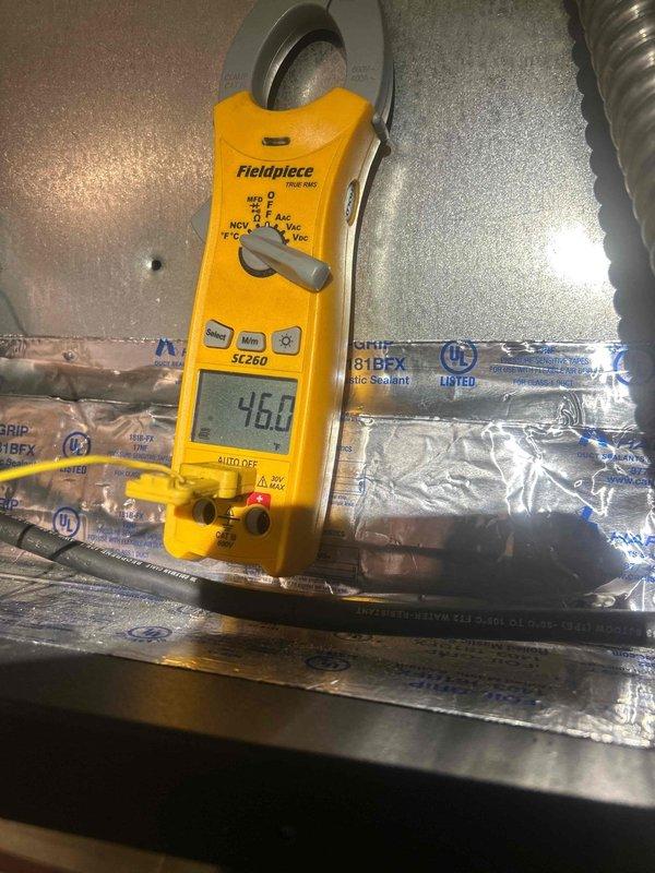 Responded to callback for non-operational AC unit with multiple prior service visits since February. Upon arrival, performed diagnostic voltage testing at the outdoor unit using clamp meter, which indicated 460V reading at the equipment. Documented electrical measurements and condenser unit connections with sealed refrigerant line set showing proper insulation and mastic sealant application. System evaluation completed and findings recorded for further troubleshooting of persistent cooling failure.