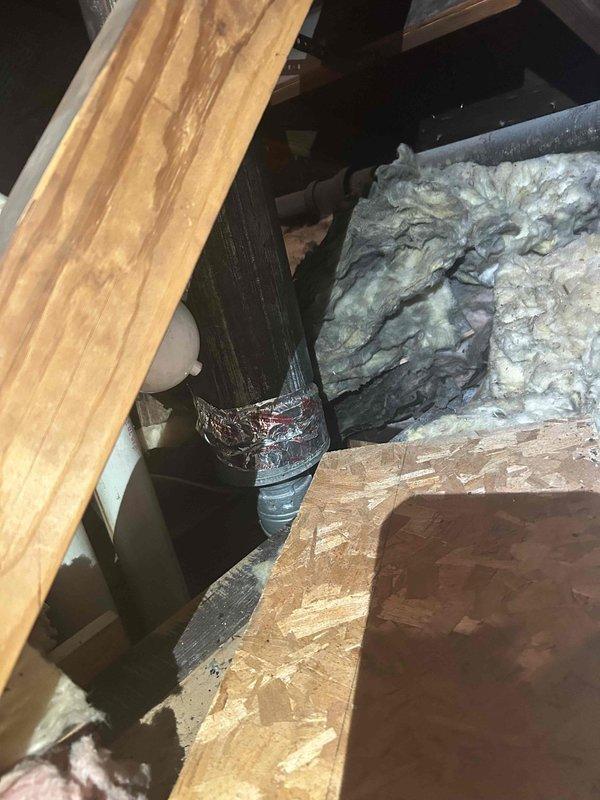 Responded to service call for disconnected HVAC exhaust pipe in attic space. Upon inspection, found flexible ductwork had separated from rigid duct connection at attic floor level. Accessed tight crawl space, repositioned and reconnected ductwork, and secured all joints to ensure proper ventilation flow. Verified system operation and confirmed exhaust routing was properly sealed and supported.