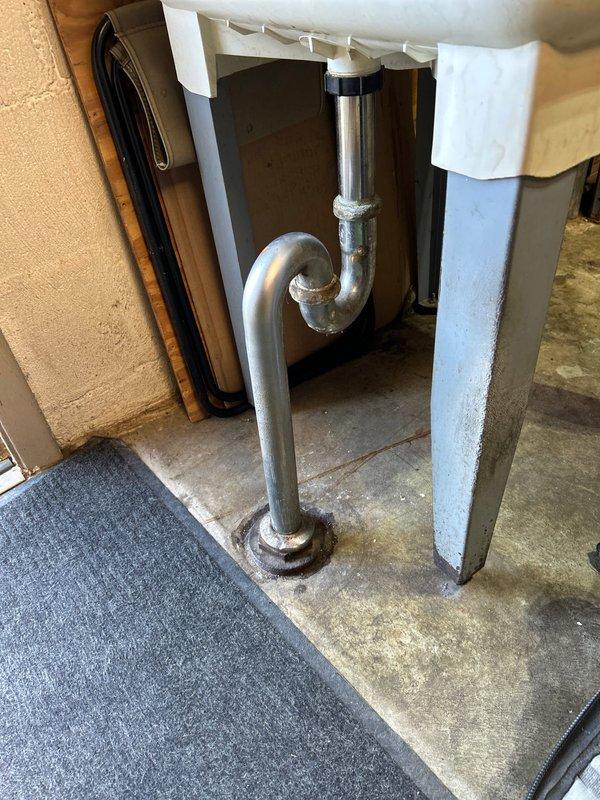 Responded to urgent call for garage utility sink faucet that was leaking and could not be shut off. Upon arrival, inspected wall-mounted faucet assembly with wheel-style valve handles serving utility sink. Diagnosed failed valve stem washer causing continuous water flow and inability to achieve complete shutoff. Disassembled valve assembly, replaced worn compression washer and valve seat, and reassembled fittings. Tested both hot and cold water supply lines for proper shutoff function and verified no leaks present. Restored full operational control of faucet valves.
