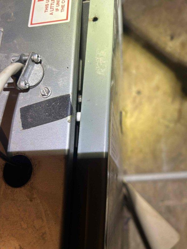 Responded to service call for thermostat with no power and non-functional HVAC system. Upon arrival, inspected 15-20 year old thermostat and traced wiring to furnace unit located in attic space. Verified power supply issues at equipment and assessed control panel connections. Documented existing system conditions including aged piping, control components, and overall unit configuration. Recommended thermostat replacement due to age and power delivery failure preventing heating and cooling operations.