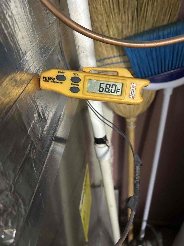 Responded to no cooling complaint on 13-year-old HVAC system. Upon arrival, confirmed unit was running but not producing cool air. Performed diagnostic evaluation using refrigeration manifold gauges and digital thermometer to assess system performance. Gauge readings indicated abnormal operating pressures with high-side pressure at 275 psig and low-side pressure at 1055 psig, along with temperature differentials of 22.1°F and 12.3°F, suggesting significant refrigerant system issues. Measured supply air temperature at 680°F, confirming lack of cooling capacity. Inspected indoor air handler unit located in hallway, examined refrigerant line set including copper suction and liquid lines, and checked system components. Based on diagnostic findings and age of equipment, provided customer with assessment of system condition and repair options necessary to restore cooling function.