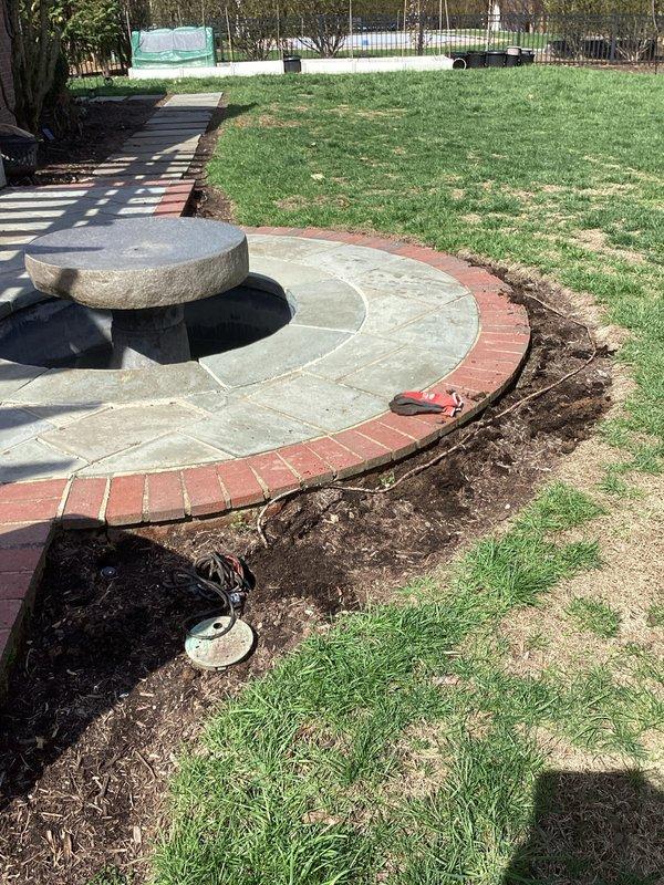 Replaced underground electrical cable for outdoor water fountain pump by fishing new wire through existing conduit path. Successfully routed cable from fountain location to existing outdoor outlet without requiring interior home access. Verified proper connection and functionality of new wiring installation for fountain pump operation.