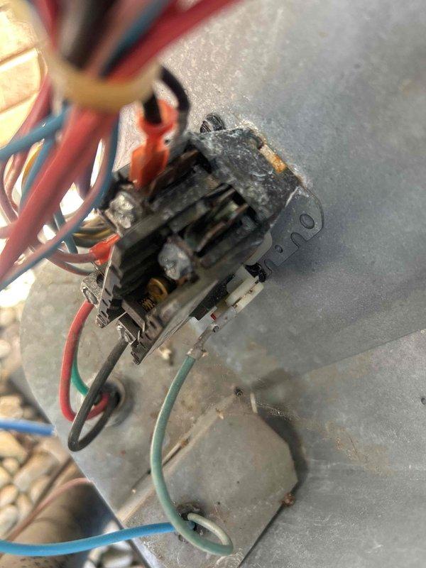 Responded to no cooling call on electric HVAC system with indoor unit located in basement. Upon inspection, discovered failed contactor relay with severe heat damage, corrosion, and charring around terminals and mounting area. Evidence of electrical arcing and thermal deterioration indicated component failure preventing compressor operation. Replaced defective contactor relay, verified all wire connections secure, and tested system operation. Unit cooling properly upon departure.