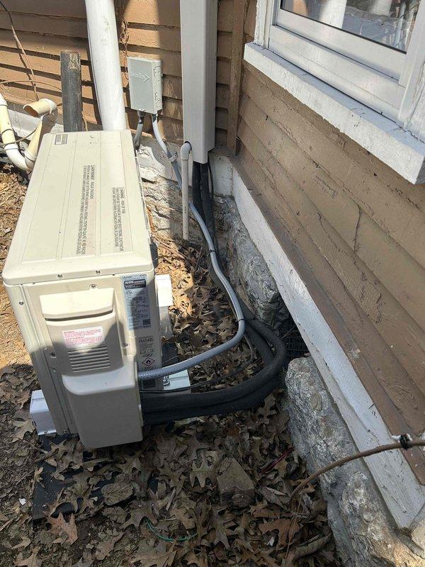 Completed residential mini-split changeout by installing Mitsubishi 18K BTU system (models MSZ-WX18NL indoor wall mount unit and MUZ-WX18NL outdoor condensing unit). Utilized existing refrigerant line set to connect indoor and outdoor components. Mounted outdoor unit on pad against exterior wall with proper electrical disconnect box and conduit installation, while indoor wall-mounted air handler was installed in bedroom location. Applied all necessary permits, removed and disposed of existing equipment, and installed electrical whip kit with disconnect box for code compliance. System tested and operational with heating capacity down to -14°F minimum operating temperature.