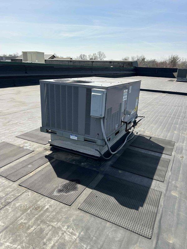Completed warranty compressor replacement on commercial rooftop packaged HVAC unit over a three-day period. Recovered refrigerant, removed failed compressor, and performed comprehensive system flush from multiple access points to remove contaminants. Installed new compressor with new filter driers, conducted pressure test, and pulled overnight vacuum to ensure system integrity. Recharged system and monitored operation, then performed secondary refrigerant recovery, additional system flush, and filter drier replacement to ensure complete contamination removal. Completed final evacuation, recharged system to manufacturer specifications, and verified proper operation. Cleaned cabinet interior and collector box as part of warranty repair protocol.