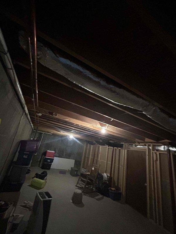 Replaced a damaged 6-inch flexible duct run with new R6 insulated flex ductwork in the basement area. The installation was completed in the unfinished space with exposed ceiling joists, ensuring proper support and connection to the existing HVAC system to restore efficient airflow.