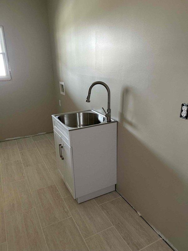 Completed whole-home plumbing fixture installation and trim-out work on existing rough-in plumbing. Installed homeowner-supplied fixtures including utility sink with gooseneck faucet in designated room. Performed system pressurization, leak testing at all connection points, and functional verification of all installed fixtures to ensure proper operation throughout the residence.