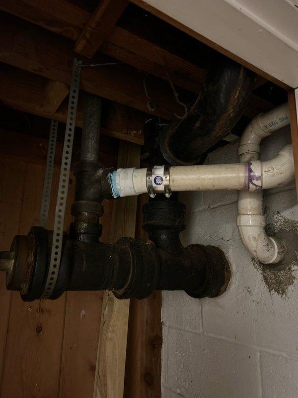 Responded to a leaking pipe issue in a seventy-year-old residential property. Upon arrival, conducted a thorough inspection of the plumbing system in the basement and attic utility areas. Located the source of the leak affecting a section of aging cast iron pipe that showed significant deterioration and corrosion consistent with the age of the home's original plumbing infrastructure.

Assessed the existing pipe configuration, which included a combination of older black iron piping and newer PVC connections. The leak originated from a compromised section where metal pipe showed advanced weathering and structural weakness. Evaluated the extent of water damage and determined the necessary repair scope to prevent further issues.

Documented the plumbing layout including horizontal drain lines, vertical risers, and connection points between dissimilar pipe materials. Photographed the affected areas showing the relationship between the cast iron sections, PVC transitions, metal couplings, an