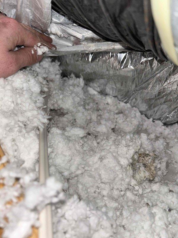 Responded to water leak concern at attic-mounted indoor HVAC unit. Upon inspection, identified condensate drainage issue occurring during cooling operation on warmer days. Accessed attic via interior stairs and examined air handler, condensate drain line, and surrounding ductwork. Found condensate line experiencing drainage restriction, causing overflow during high-humidity cooling cycles. Cleared blockage from drain line and verified proper drainage flow. Inspected insulation for water damage and confirmed air handler drain pan functioning correctly. System tested under cooling operation with no further leakage observed.
