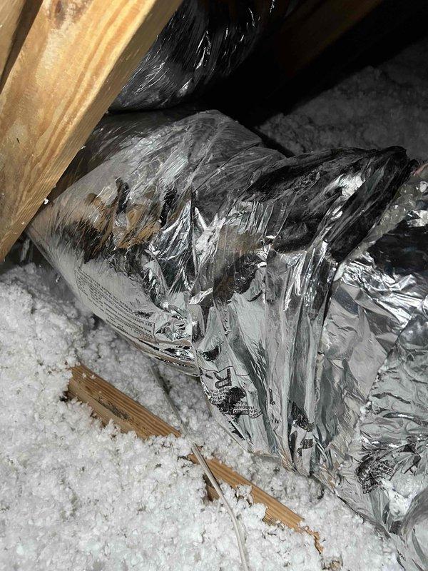 Responded to water leak concern at attic-mounted indoor HVAC unit. Upon inspection, identified condensate drainage issue occurring during cooling operation on warmer days. Accessed attic via interior stairs and examined air handler, condensate drain line, and surrounding ductwork. Found condensate line experiencing drainage restriction, causing overflow during high-humidity cooling cycles. Cleared blockage from drain line and verified proper drainage flow. Inspected insulation for water damage and confirmed air handler drain pan functioning correctly. System tested under cooling operation with no further leakage observed.