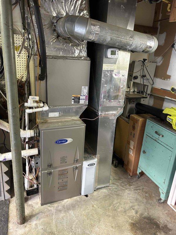 Completed Gold Level prepaid maintenance on a single-system residential HVAC installation. Inspected Carrier furnace/air handler unit located in basement utility area and outdoor condensing unit (Model CNPVP4221ALAAAA, Serial 1713X18113) containing R-410A refrigerant. Provided and installed customer-supplied air filter #413 as part of membership benefits during spring maintenance visit. Verified all manufacturer specification labels, safety warnings, and refrigerant information were legible and intact on both indoor and outdoor equipment. Documented equipment condition through photographs showing ductwork connections, humidifier attachment, electrical wiring, and overall system operation.