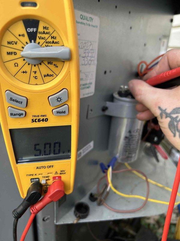 Completed comprehensive care plan tune-up on attic-mounted air conditioning unit with gas furnace system. Performed electrical diagnostics using digital multimeter, measuring capacitor voltage at 5.00V and contactor voltage at 26.2V to verify proper component operation. Inspected system wiring and connections, confirmed all electrical components functioning within normal parameters, and noted unit requires 20x20x1 filters which are not included in service plan.