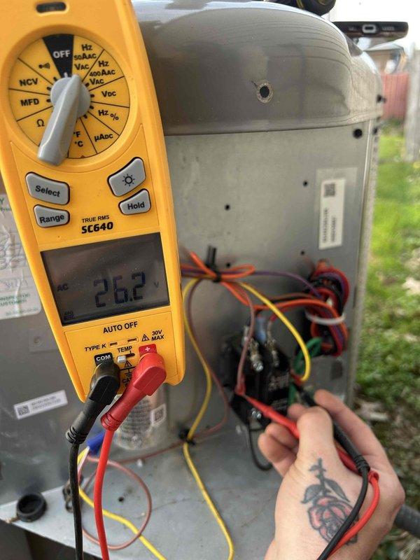 Completed comprehensive care plan tune-up on attic-mounted air conditioning unit with gas furnace system. Performed electrical diagnostics using digital multimeter, measuring capacitor voltage at 5.00V and contactor voltage at 26.2V to verify proper component operation. Inspected system wiring and connections, confirmed all electrical components functioning within normal parameters, and noted unit requires 20x20x1 filters which are not included in service plan.
