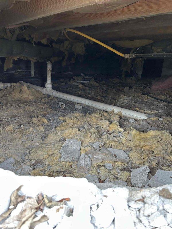 Returned to property to address accessibility concerns regarding downstairs zone ductwork. Located and accessed crawl space entry point through dedicated exterior access panel. Conducted thorough inspection of supply ducting for downstairs zone, which is partially buried in dirt floor with compromised insulation throughout crawl space. Documented conditions with photographs showing exposed floor joists, scattered fiberglass insulation, and flexible ductwork running through space. Measured airflow at downstairs registers and confirmed reduced performance due to dirty 20x24x1 filter and compromised duct conditions. Reviewed all findings and photographic documentation with property owner to provide complete system evaluation.