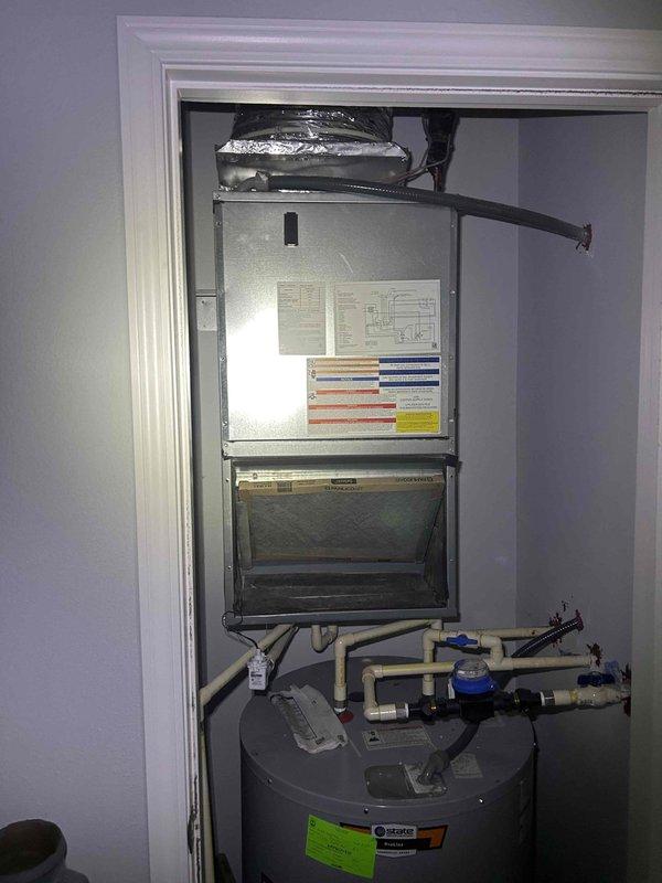 Responded to no cooling call on 2-year-old electric HVAC system. Upon arrival, located air handler unit in utility closet and verified thermostat was set to cooling mode at 70 degrees. Performed diagnostic evaluation of system components to identify cause of cooling failure and documented equipment condition with photos for service records.