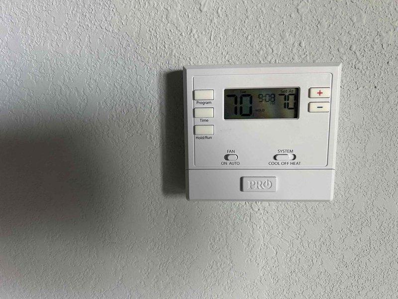 Responded to no cooling call on 2-year-old electric HVAC system. Upon arrival, located air handler unit in utility closet and verified thermostat was set to cooling mode at 70 degrees. Performed diagnostic evaluation of system components to identify cause of cooling failure and documented equipment condition with photos for service records.