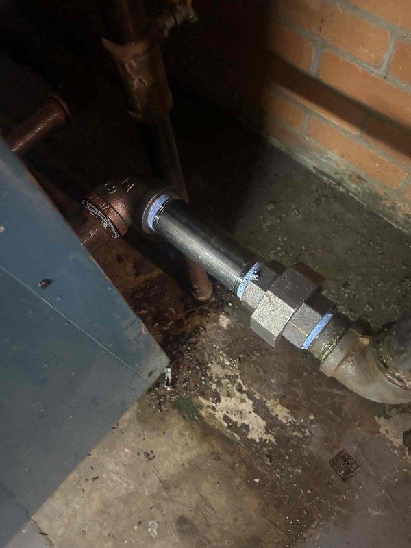 Responded to commercial no heat call for 70-year-old boiler system located in basement. Upon arrival, diagnosed failed circulator pump motor on vertical piping, which customer indicated had been previously replaced approximately 10 years ago. Replaced defective circulator pump assembly with new unit, restored proper water circulation through the hydronic heating system, and verified operational functionality. Documented existing corroded copper piping connections and overall aging condition of boiler infrastructure with photographic evidence for service records.