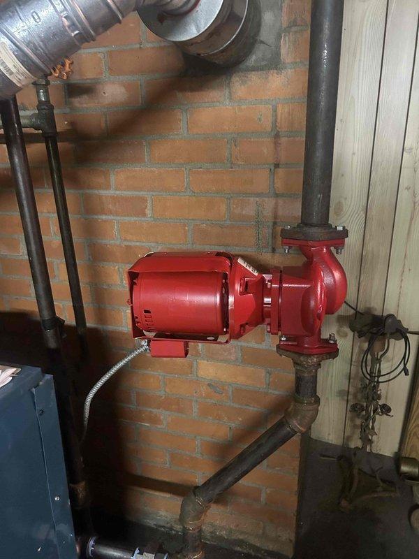 Responded to commercial no heat call for 70-year-old boiler system located in basement. Upon arrival, diagnosed failed circulator pump motor on vertical piping, which customer indicated had been previously replaced approximately 10 years ago. Replaced defective circulator pump assembly with new unit, restored proper water circulation through the hydronic heating system, and verified operational functionality. Documented existing corroded copper piping connections and overall aging condition of boiler infrastructure with photographic evidence for service records.