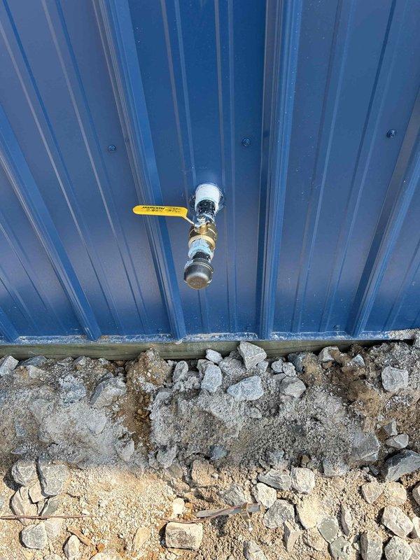 Installed complete gas piping system to supply two tankless water heaters in a residential or light commercial structure. Ran gas lines through interior wall framing with proper support and securing methods, installed exterior gas shutoff valve with yellow-handle ball valve on corrugated metal exterior wall, and ensured all connections meet code requirements for safe operation. All piping was properly sized and routed to accommodate dual tankless water heater installation.