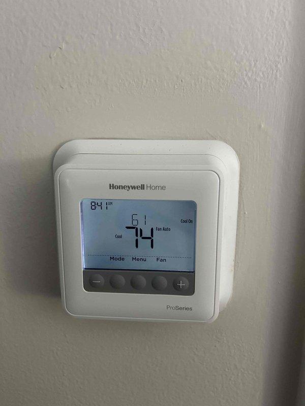 Responded to a no cooling complaint on a 13-year-old electric HVAC system with the indoor unit located in the attic. Upon arrival, thermostat displayed 74°F with system calling for cooling but inadequate temperature reduction reported over the past couple days. Inspected air filter behind return grille, which appeared clean with intact pleated media, though customer was unable to confirm last replacement date.