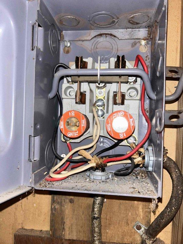 Responded to no hot water complaint on recently installed tank water heater. Upon arrival, confirmed complete loss of hot water throughout residence for three days. Customer had previously attempted troubleshooting by checking and replacing fuses without resolution.

Inspected electrical disconnect box serving water heater. Found two 18-amp and 30-amp fuse holders with brass bus bars and multiple wire connections. Observed accumulated debris and dust in bottom of enclosure. Tested electrical continuity and verified proper fuse sizing for water heater load requirements. Checked all wire connections at terminals for tightness and proper installation. Verified power supply to unit and tested heating elements for functionality. Restored hot water service to residence. Documented electrical panel condition with photographs for service records.