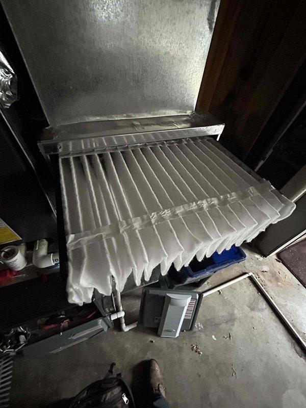 Completed comprehensive care plan tune-up on 2022 AC/gas furnace system located in basement. Upon inspection, discovered evaporator coil completely covered in thick frost and ice buildup, indicating restricted airflow or refrigerant issues. Assessed outdoor condensing unit, inspecting electrical components, capacitor, and control module (CorSense system). Documented frozen coil condition and electrical panel configuration with photographic evidence. Customer to provide filters for system maintenance.