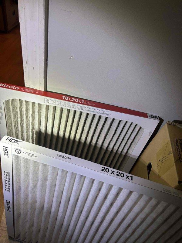 Responded to no cooling call on 1-year-old electric HVAC system displaying system alert at thermostat. Upon arrival, found air handler installed in laundry room with multiple replacement filters staged nearby. Performed diagnostic evaluation of indoor unit and electrical connections. Inspected wire terminations at unit with orange wire nuts visible at top connections. Verified filter had been changed approximately one month prior. System alert condition preventing cooling operation was addressed, restoring normal functionality to the air conditioning system.