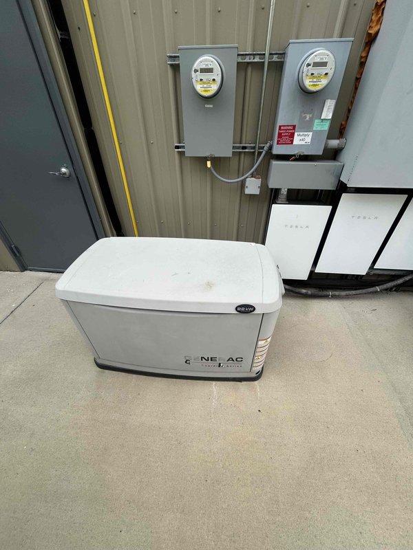 Performed routine electrical maintenance and inspection on Evolution-branded backup generator system integrated with Tesla Powerwall battery storage and utility metering infrastructure. Generator control panel displayed 46.0 run hours at time of service. Verified proper operation of AUTO/MANUAL/OFF selector switch, control interface functionality, and digital display readout accuracy. Documented current system configuration including Generac generator unit, dual utility meters, Tesla Powerwall units, and associated electrical conduit connections. All components operational and system ready for automatic transfer switch activation during utility outages.