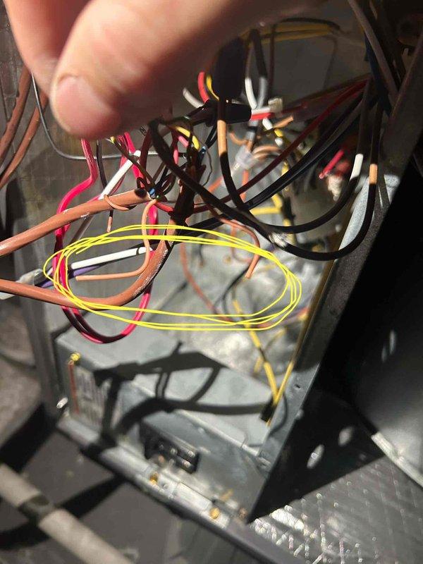 Responded to service call for HVAC unit operating in heat mode when thermostat was set to cooling. Inspected system wiring and electrical connections, reviewed previous inspector documentation and photographs regarding condensate line discharge locations and equipment specifications. Assessed whether current equipment capacity is appropriately sized for the property's heating and cooling load requirements.