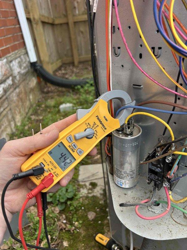 Responded to a no cooling call on a 10-year-old electric HVAC system for a second opinion evaluation. Upon arrival, performed diagnostic testing of the outdoor unit's electrical components, including amperage draw measurements on the compressor circuit using a clamp meter, which registered 449 amps. Inspected the run capacitor and contactor relay for proper operation and physical condition. Evaluated the system's refrigerant circuit based on the previous company's assessment of a refrigerant leak requiring a seal replacement. Checked the programmable thermostat in cooling mode, which was set to 67°F with a scheduled setpoint of 65°F. Verified recent filter maintenance had been completed. Provided findings and recommendations to the customer regarding the system's condition and available repair versus replacement options for their upstairs bedroom unit.