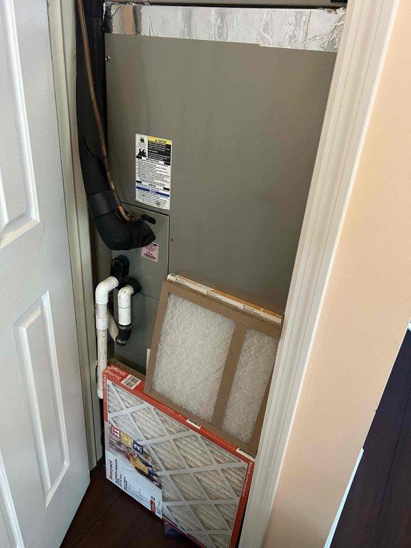Responded to system fault error displayed on heating and cooling unit while system remained operational. Inspected air handler unit in utility closet, verified refrigerant lines and electrical connections, and confirmed outdoor sensor module was properly mounted and functioning. Checked air filtration system and determined all components were operating within normal parameters despite error code display.