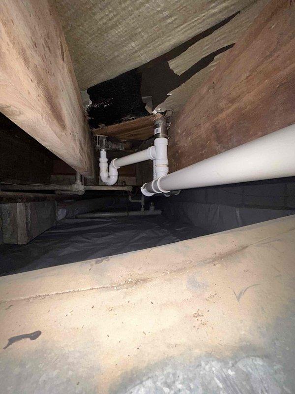 Completed annual tanked water heater maintenance and flush service as part of the USA Bronze preventative maintenance program. Inspected water heater installation in crawl space area, including supply and drain plumbing connections, verified proper pipe support and insulation integrity, and documented existing plumbing configuration with PVC drainage system and copper supply lines. Performed standard water heater flush procedure to remove sediment buildup and ensure optimal performance and efficiency.
