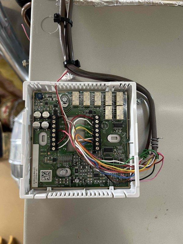 Responded to service call for downstairs HVAC system not operating with E1 error code displaying on thermostat. Inspected control board and electrical connections in basement air handler unit. Verified all wire terminations secure at terminal blocks, checked capacitors and control circuitry for proper operation. Documented control board configuration and wiring connections. System evaluated for any correlation to recent service work performed at property.
