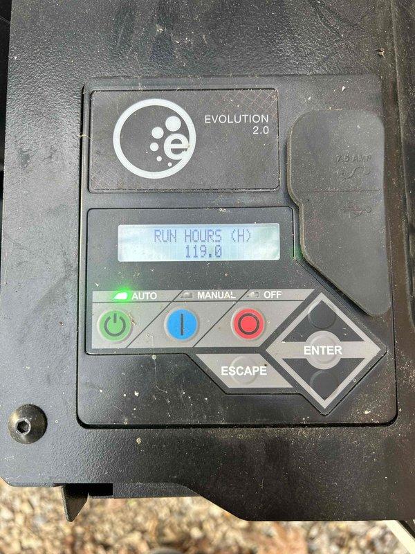 Completed annual generator maintenance and replaced the transfer mechanism in the transfer switch. The generator control panel displayed 119 hours of runtime on the Evolution 2.0 system, which is now operating properly in AUTO mode with WiFi monitoring service activated for one year of remote system oversight.