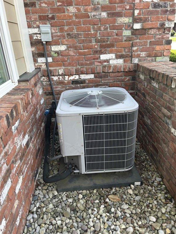Completed routine AC tune-up on an eleven-year-old cooling system. Performed electrical diagnostics using clamp meter to verify proper amperage draw and system performance. Inspected outdoor condensing unit, capacitor dated from previous service, and all electrical connections. Indoor air handler located in upstairs bedroom is nine years old with customer-supplied filters. System operating within normal parameters with no repairs needed at this time.